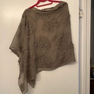 Sheer asymmetrical poncho with raw edge flower detailing.